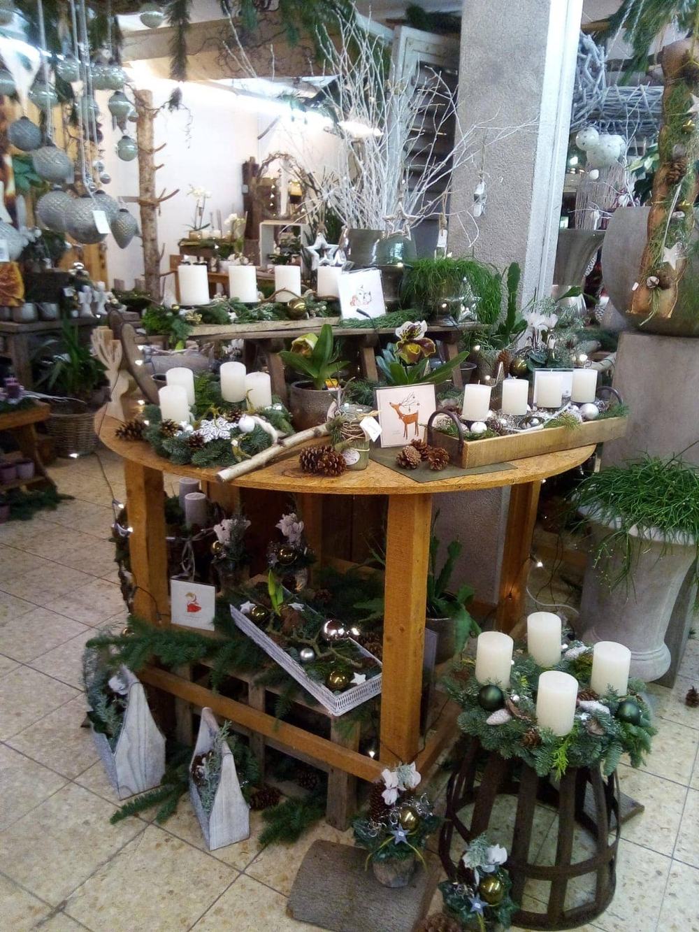 Adventsausstellung im Laden mit Kerzen, Kränzen und Gestecken