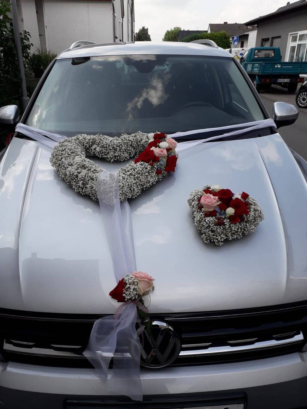 Autoschmuck mit Blumenherzen auf der Motorhaube